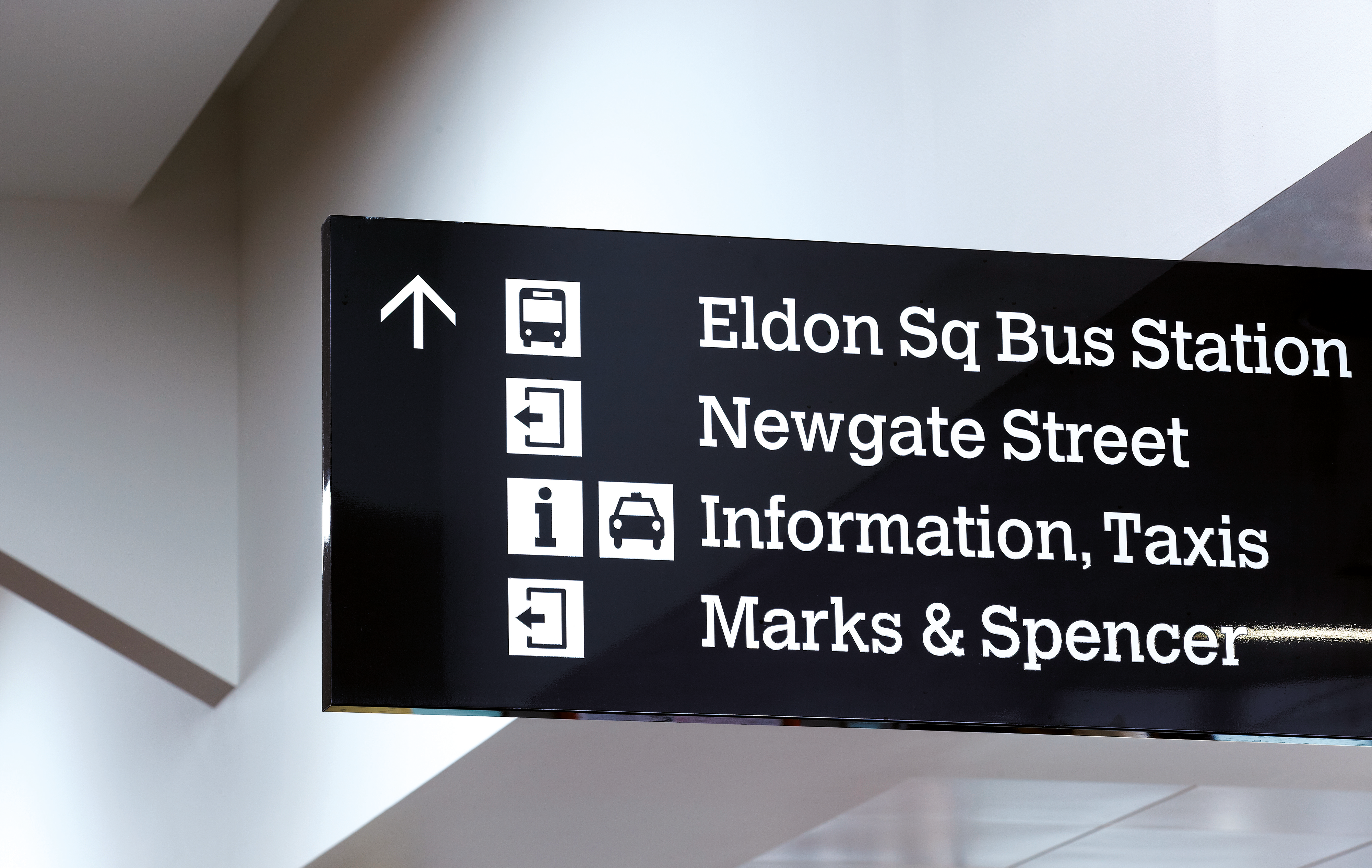 A sign showcasing where to go for a bus station, information, taxis and more