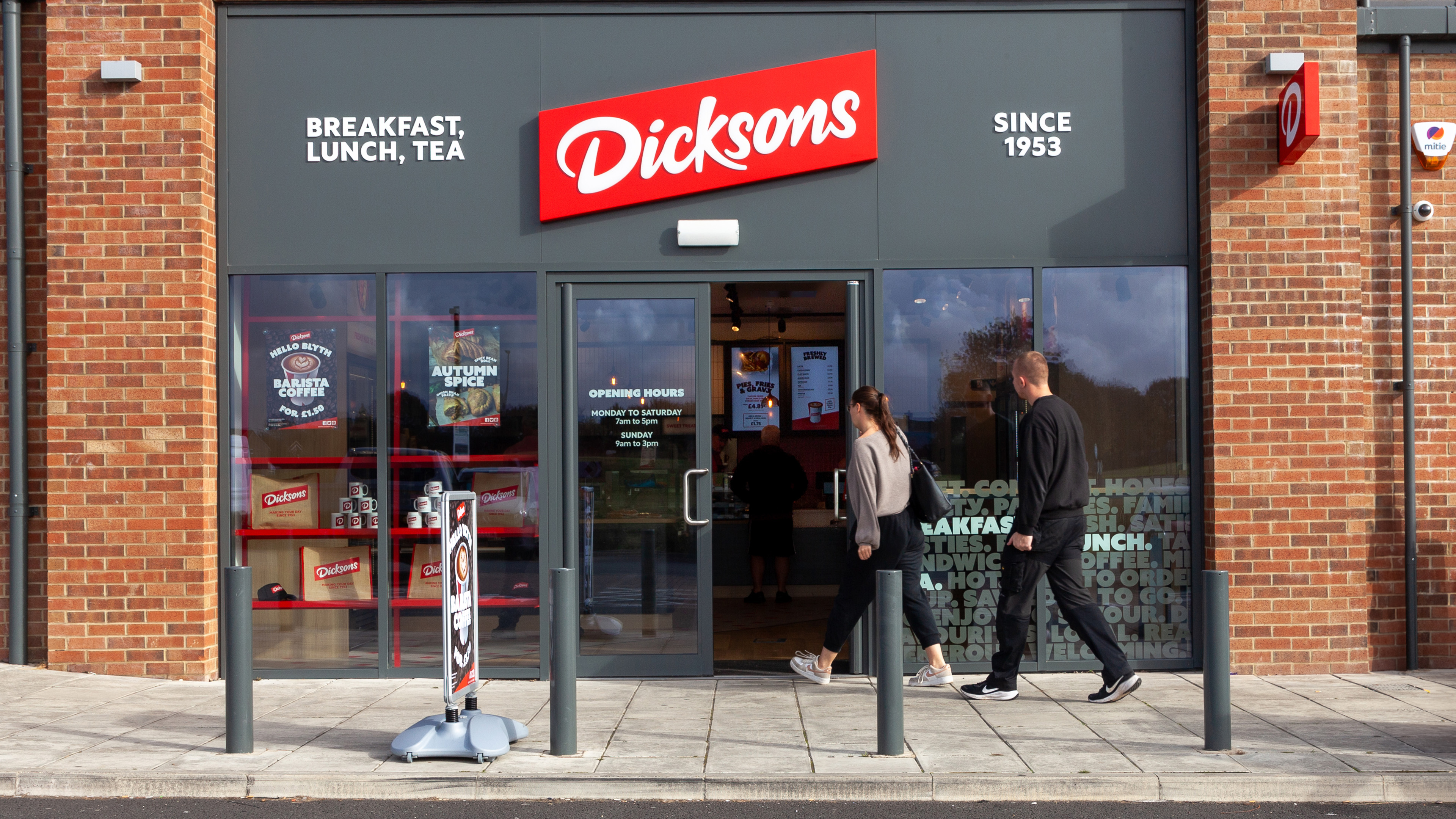 People walking into store.