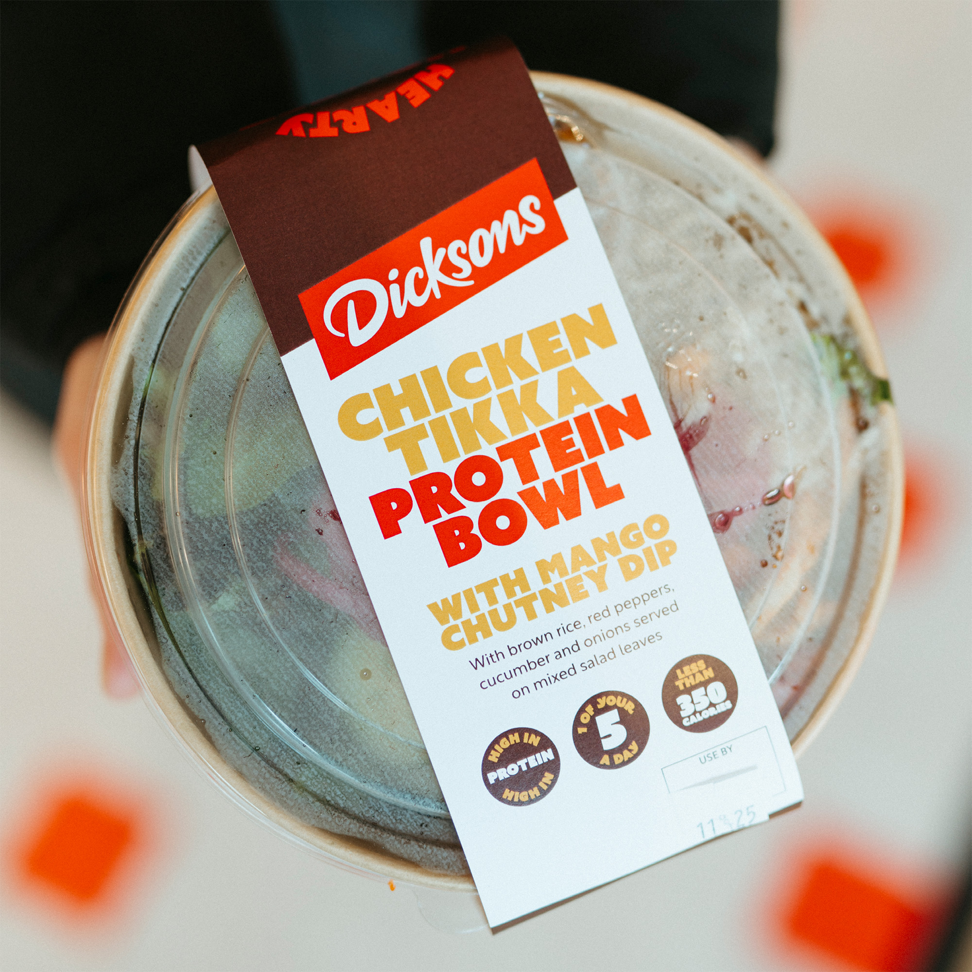 Person holding box of food.