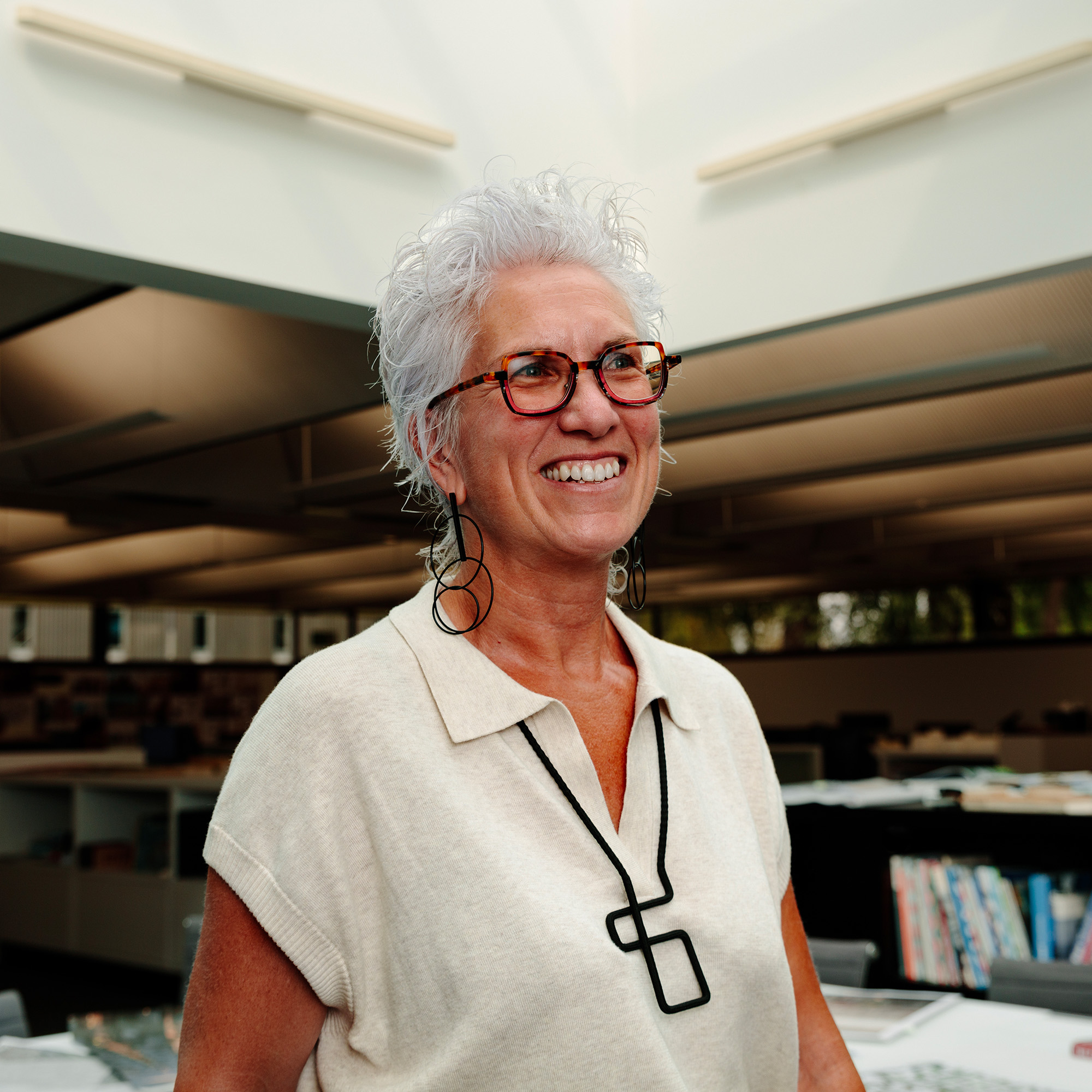 Tania Love, Director at FaulknerBrown smiling during a meeting.