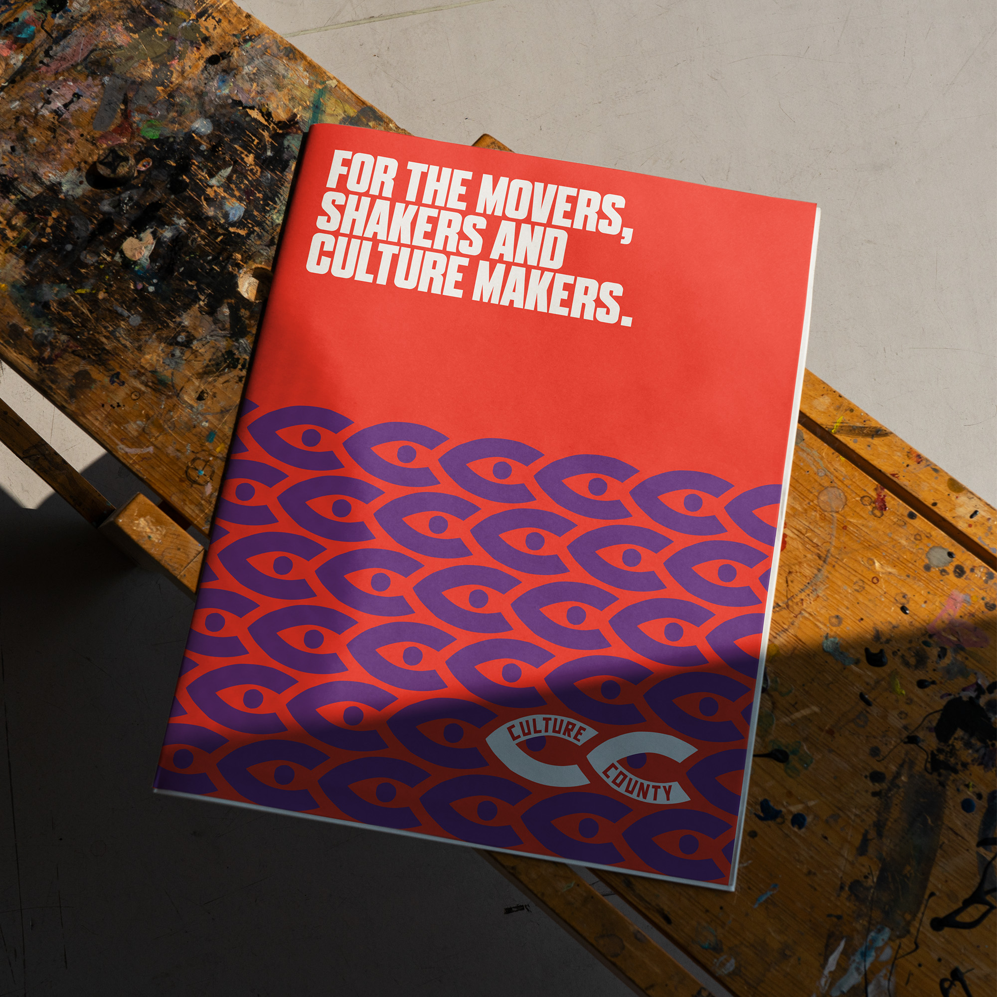 Colourful A4 magazine resting on wooden bench