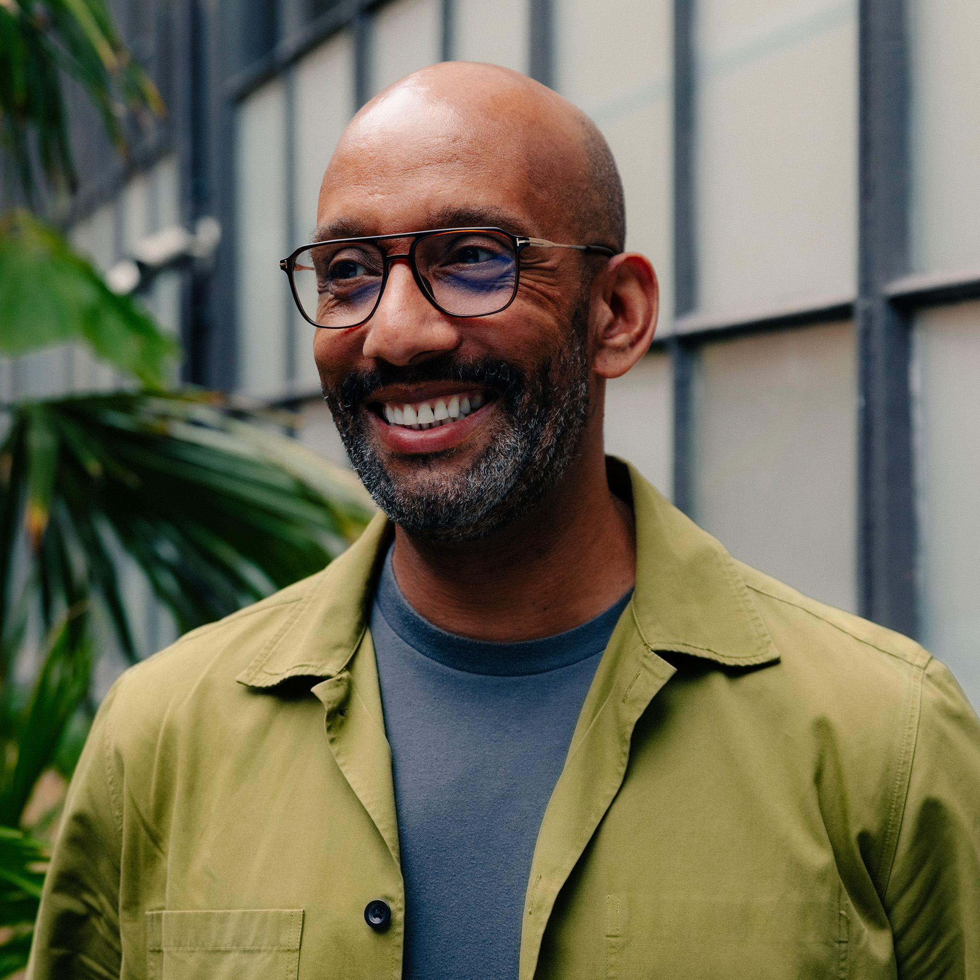 Architect in London smiling during RIBA meeting.