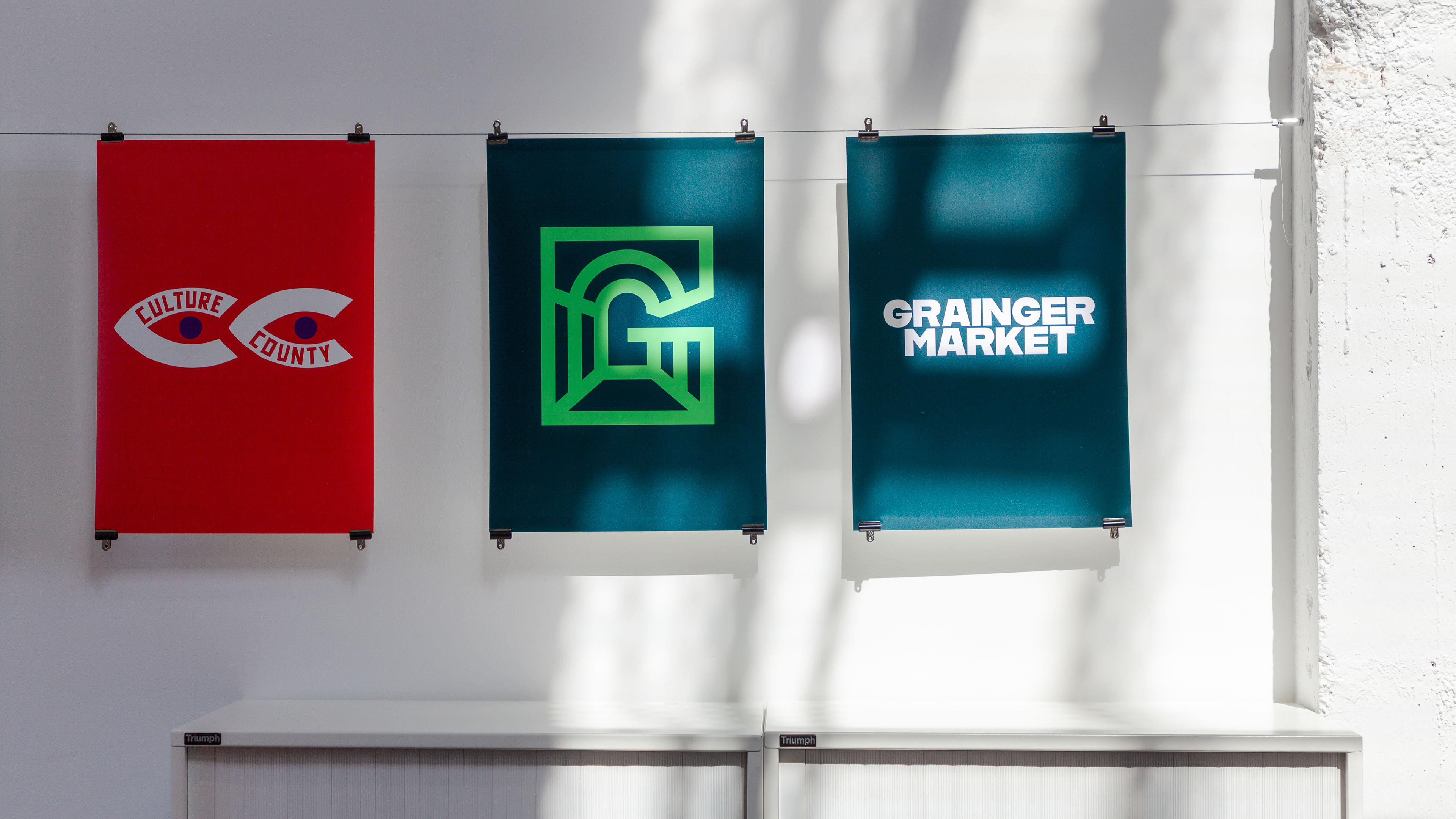 Posters hanging from a white background