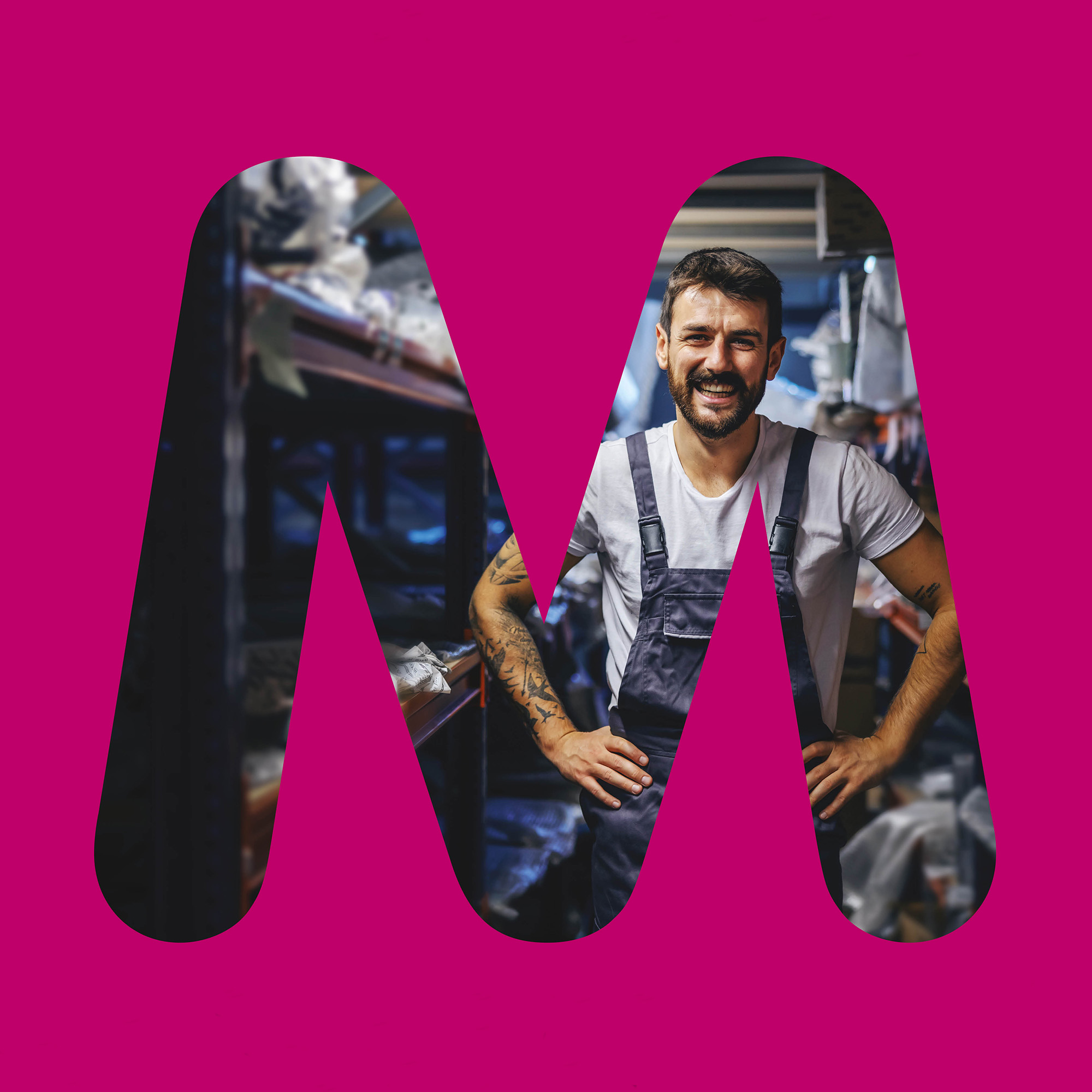A man in work clothes inside the letter M