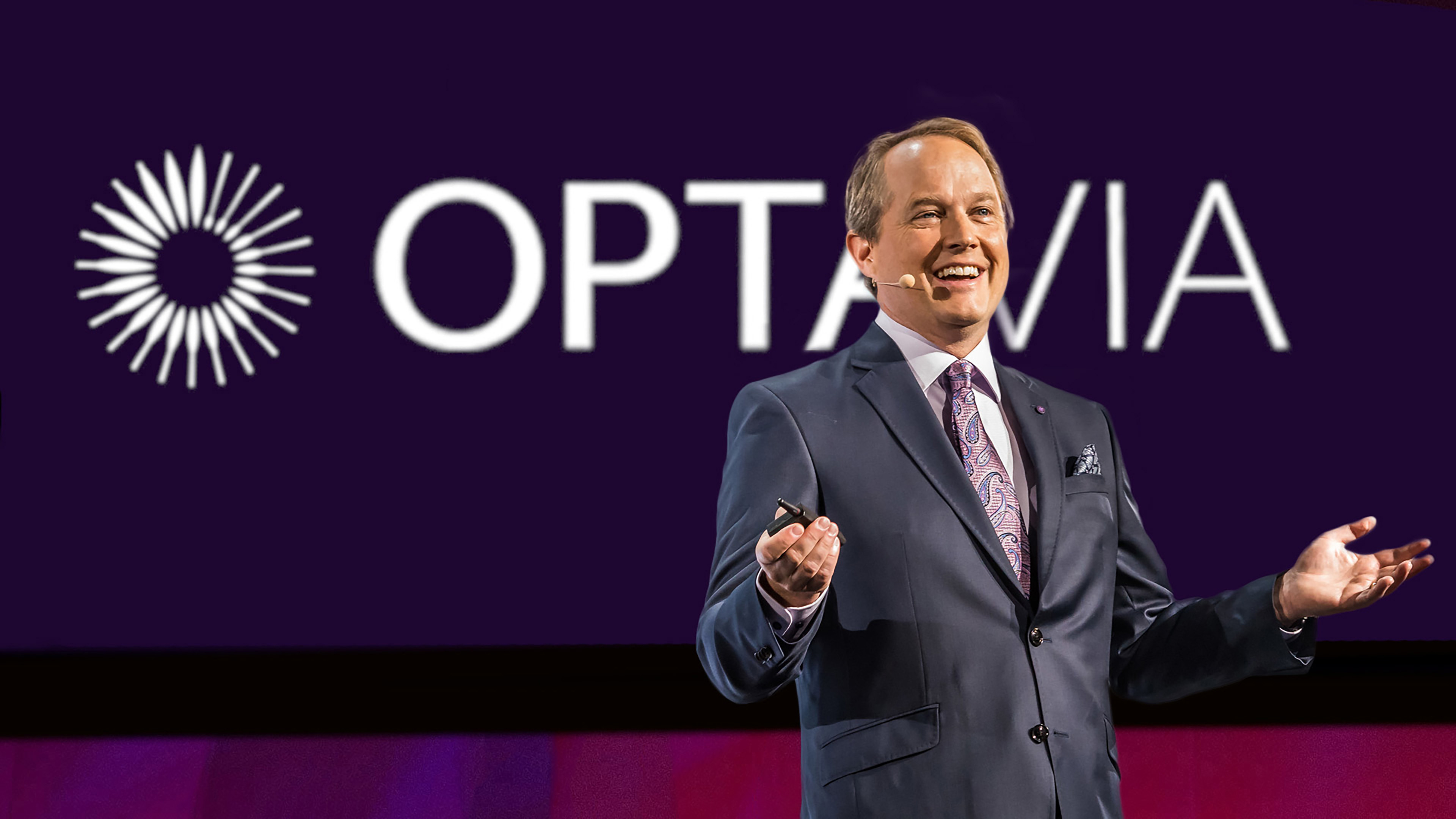 A man with a microphone on a stage