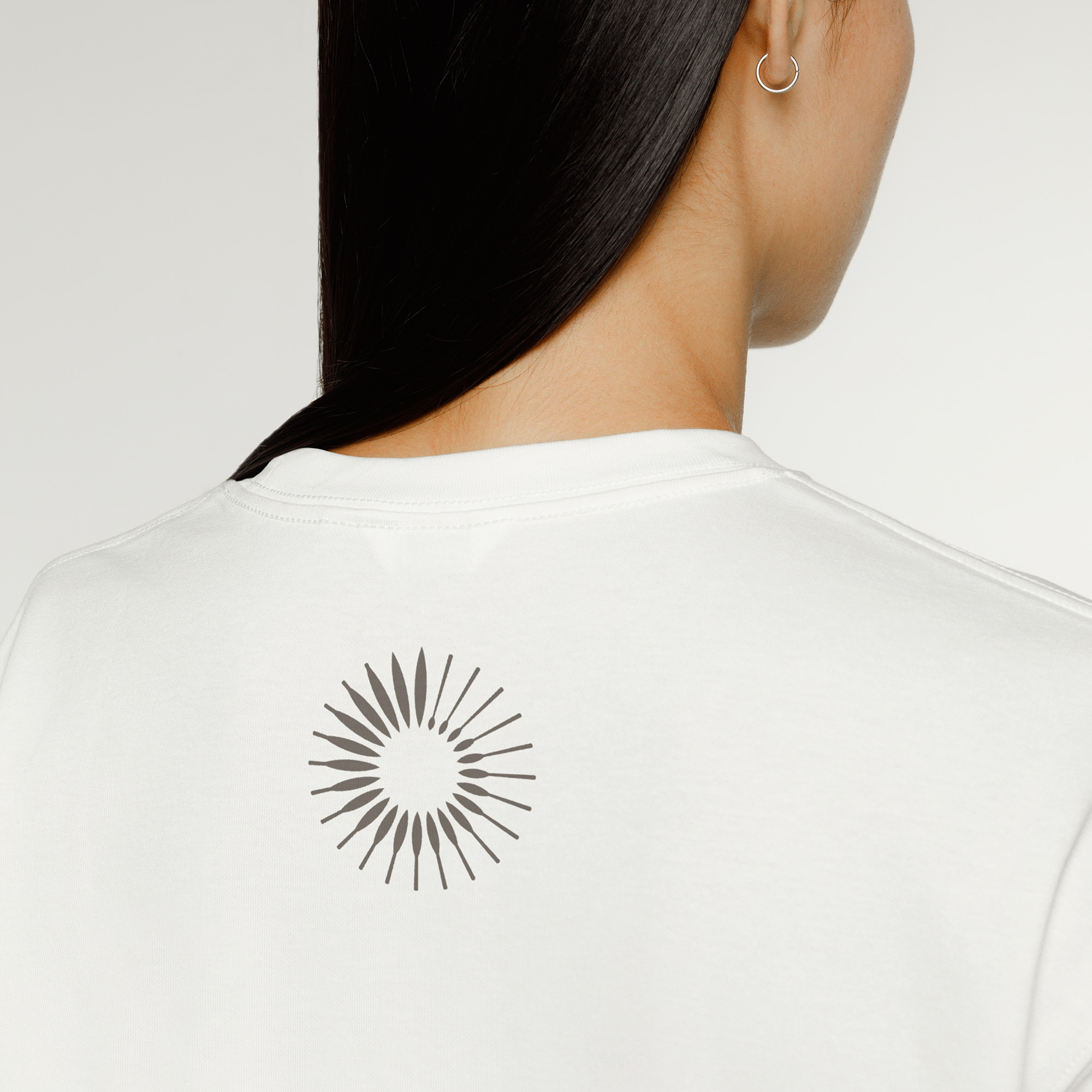 The back of someone's head wearing a white t-shirt