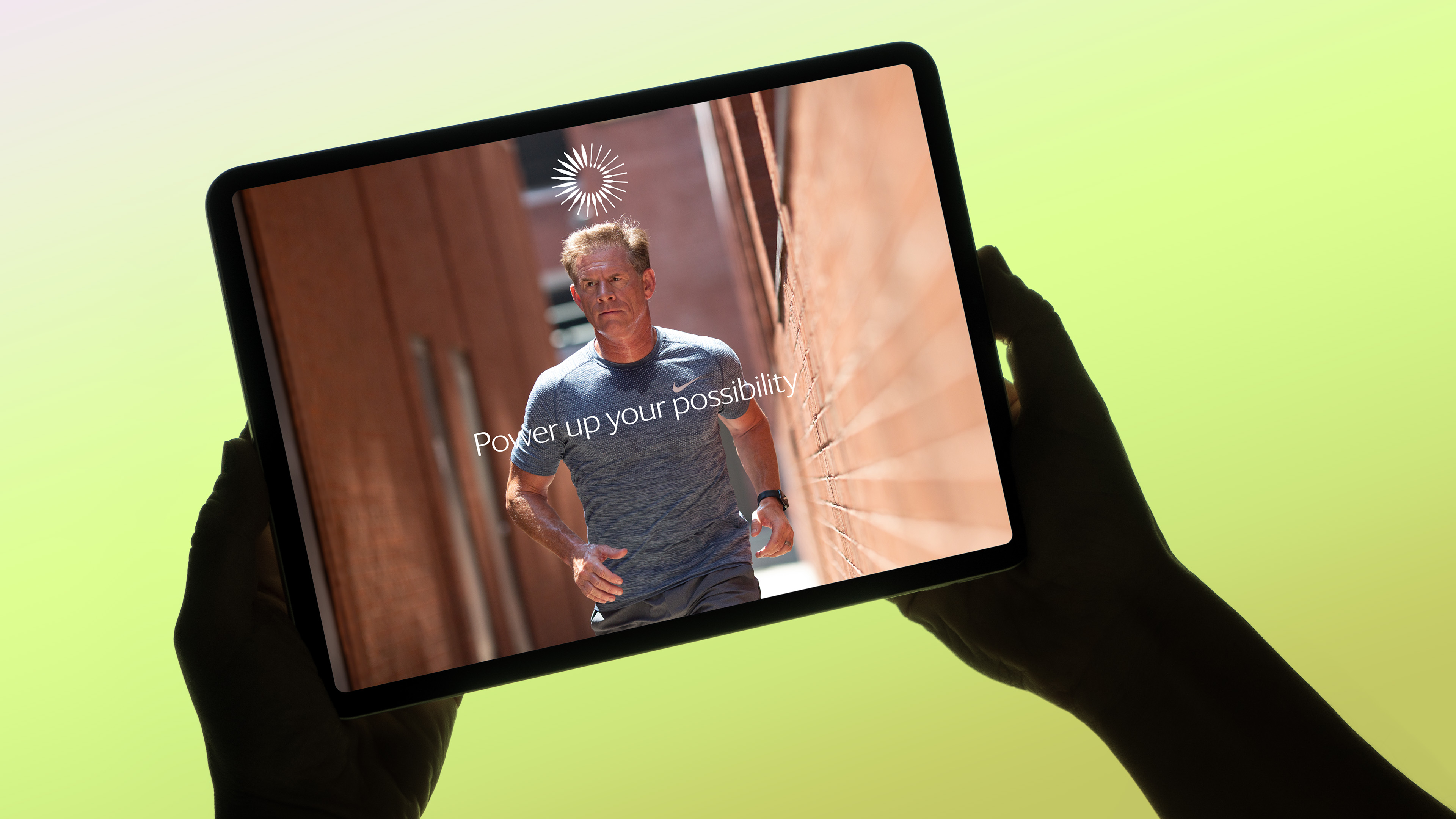 Someone holding a screen showing a man running