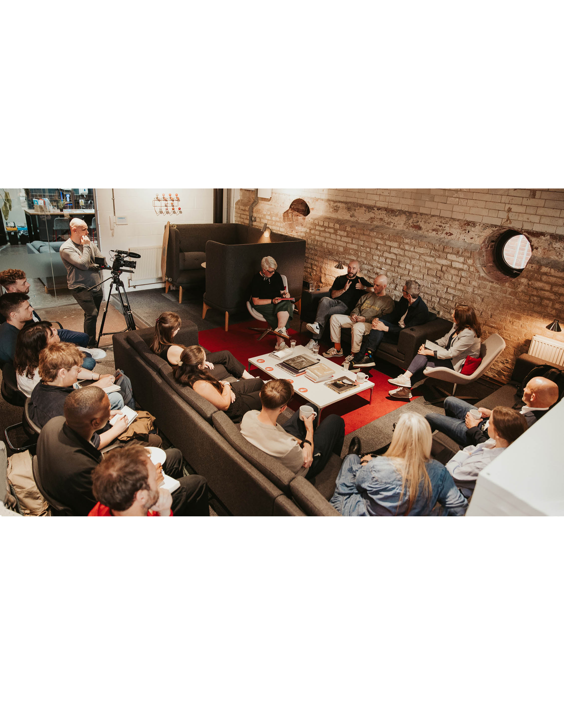 A group of people sitting in rows in an office space