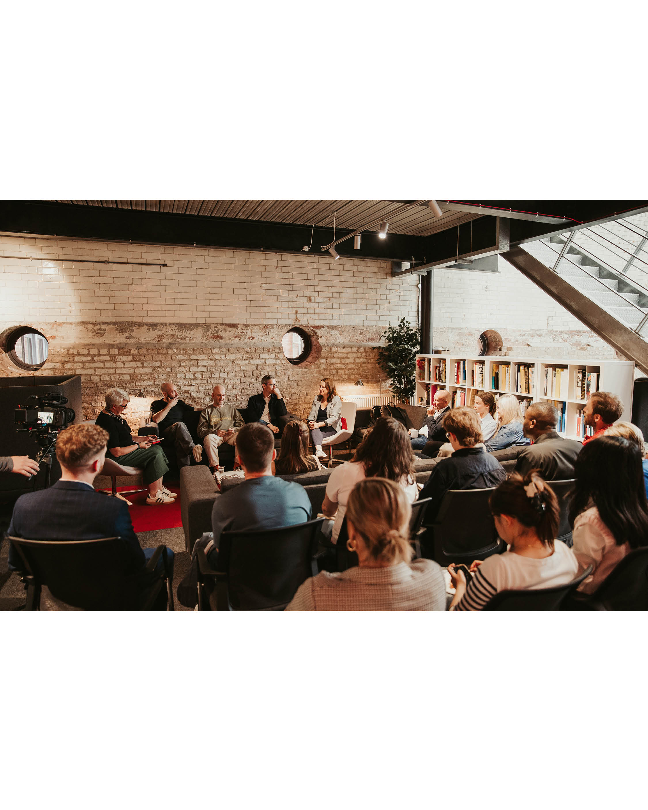 An image of people sitting in a busy office