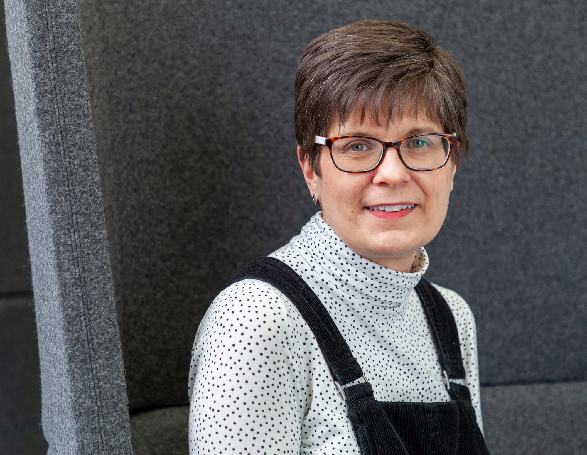 Sarah sitting in a pod in the office.
