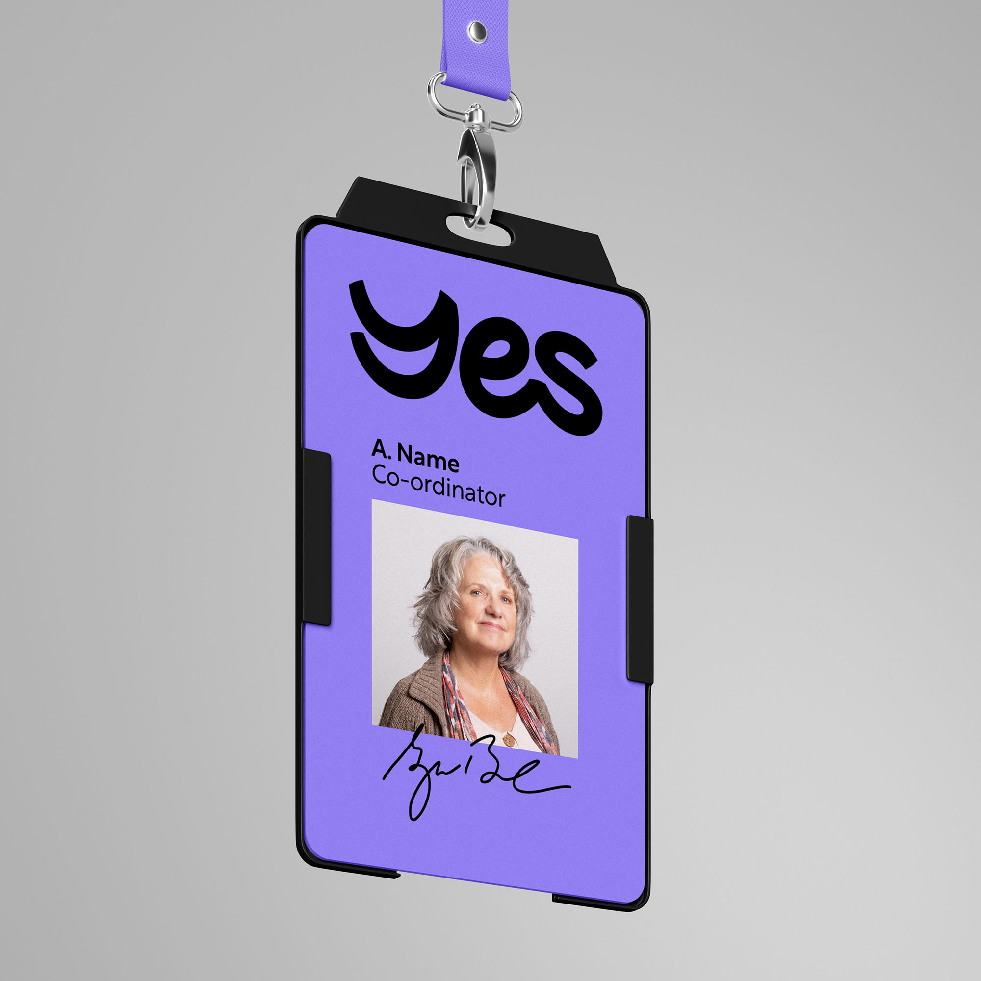 YES branded name badge on grey background.