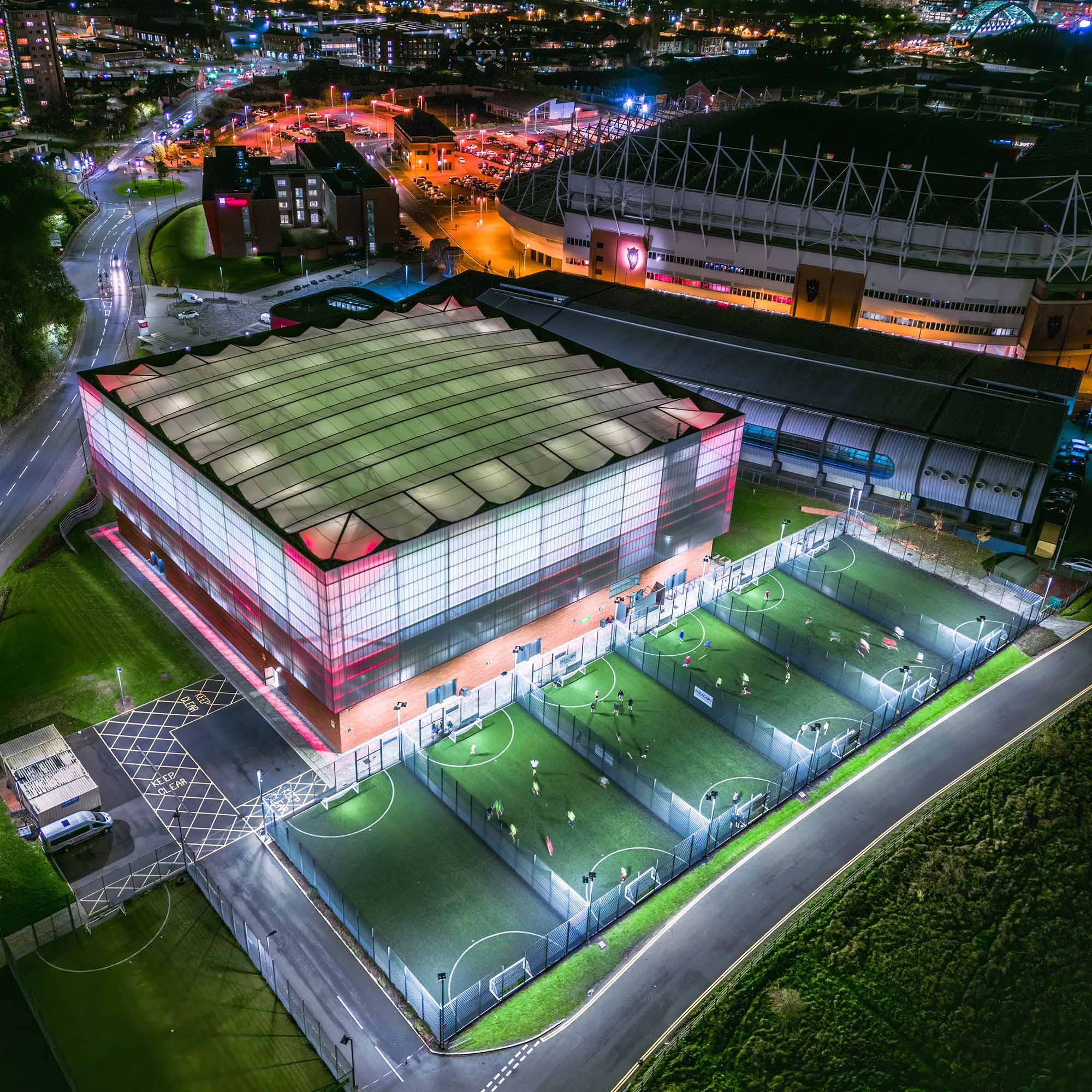 Aerial night view of the Beacon of Light building showing its close proximity to the Stadium.