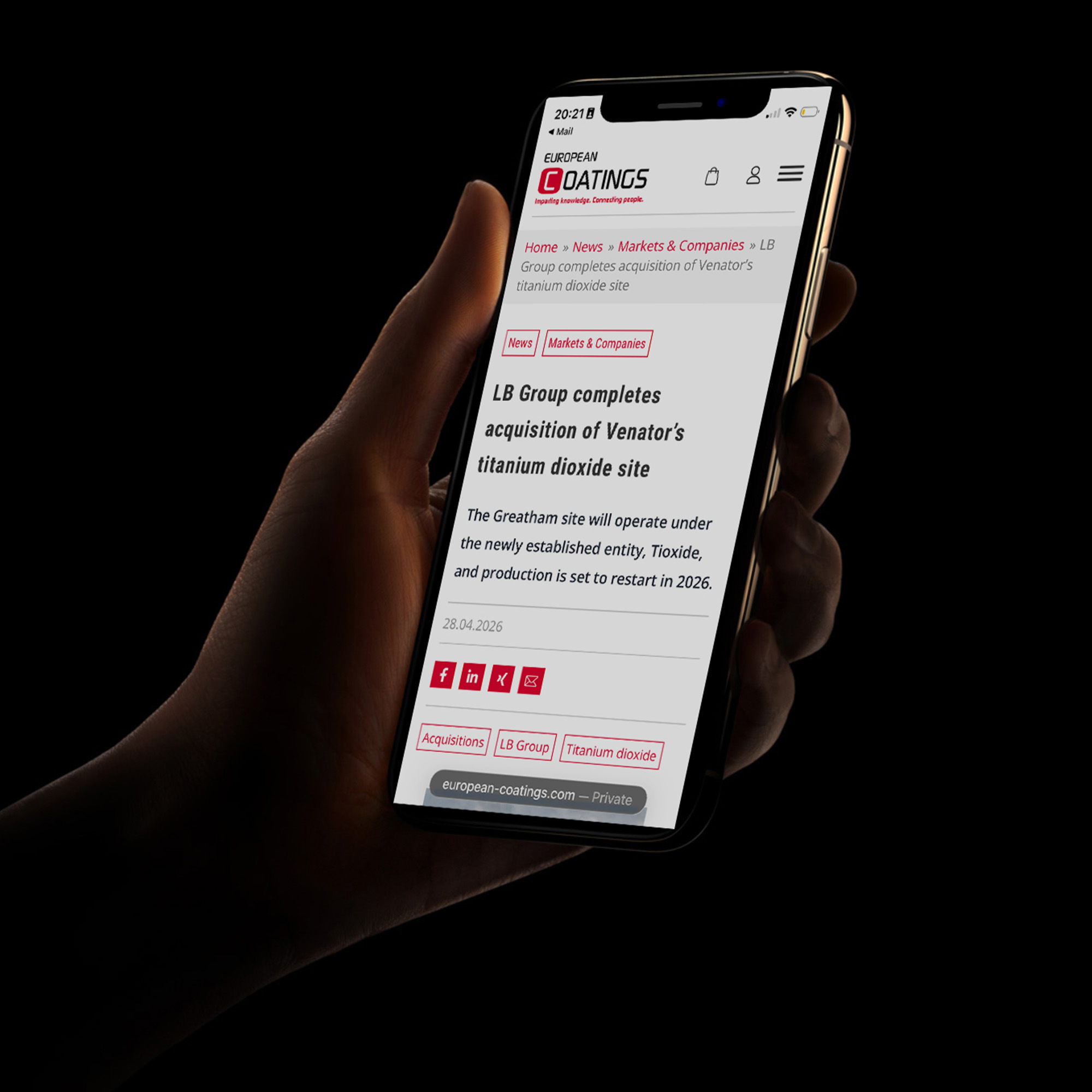 Hand held mobile phone showing media coverage of the Tioxide purchase by LB Group