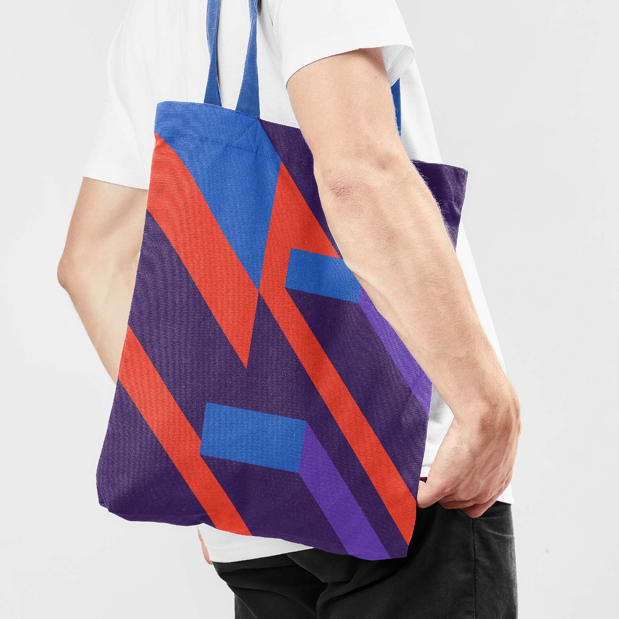 Brightly coloured graphic detail from the identity system printed on a tote bag worn over the shoulder of a young man against a white background