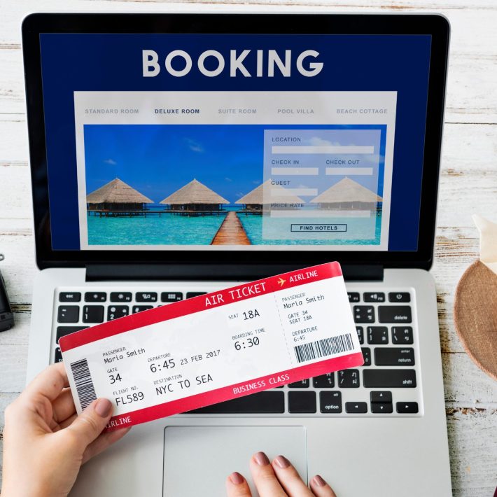 Plane ticket over a laptop