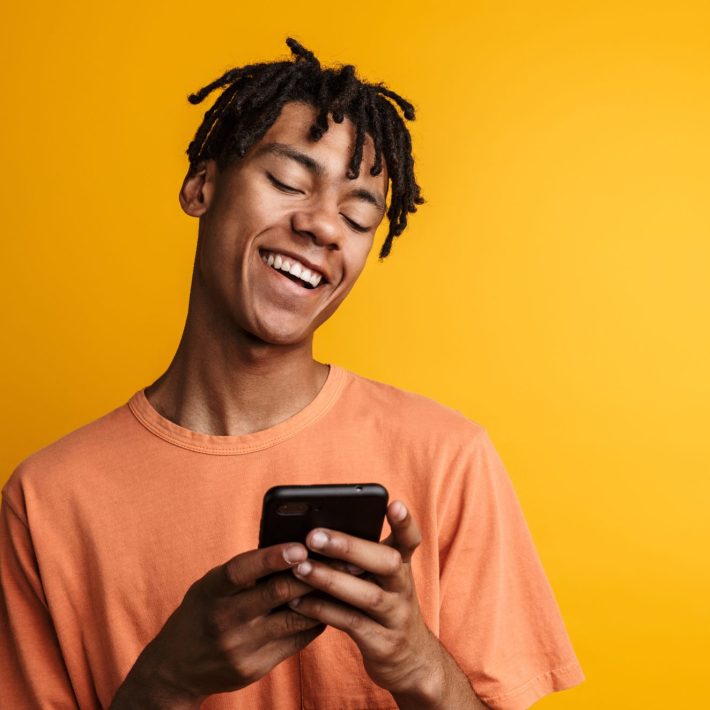 Man smiling at his cell phone