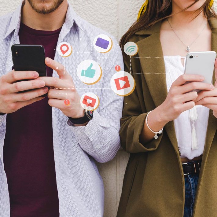 Two people using social media on their cell phones