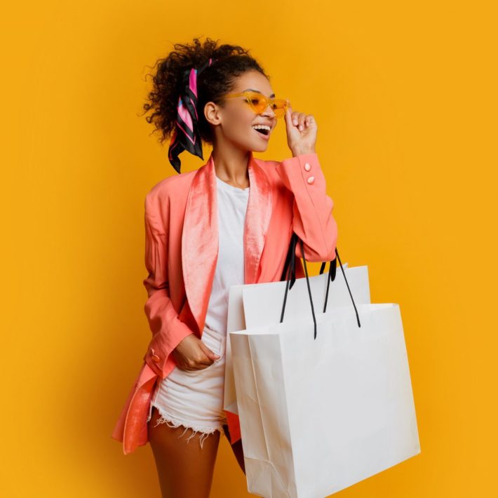 A happy woman holding shopping bags