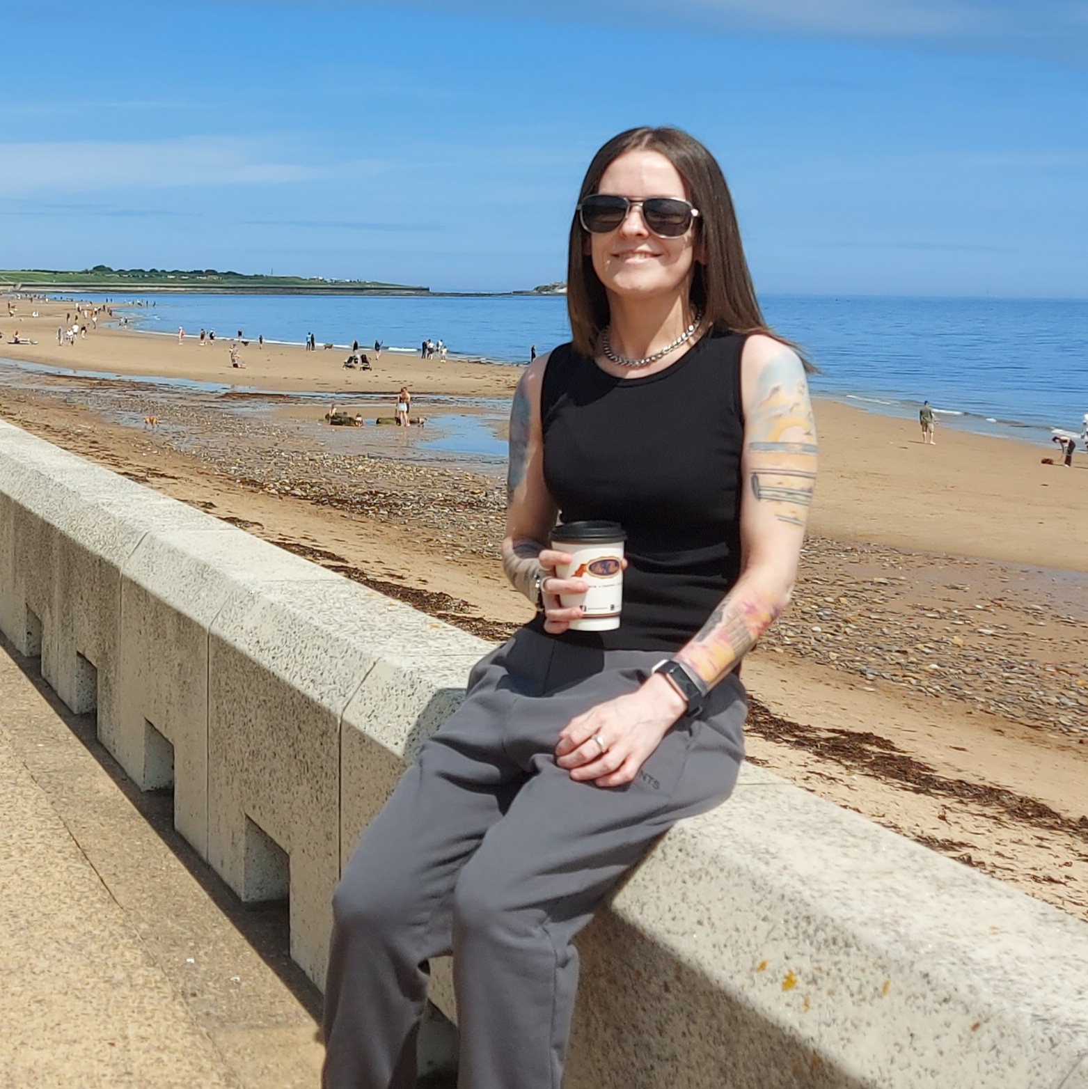 A woman sitting by the coast